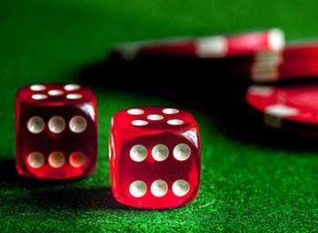 close-up of dice and chips on a craps table